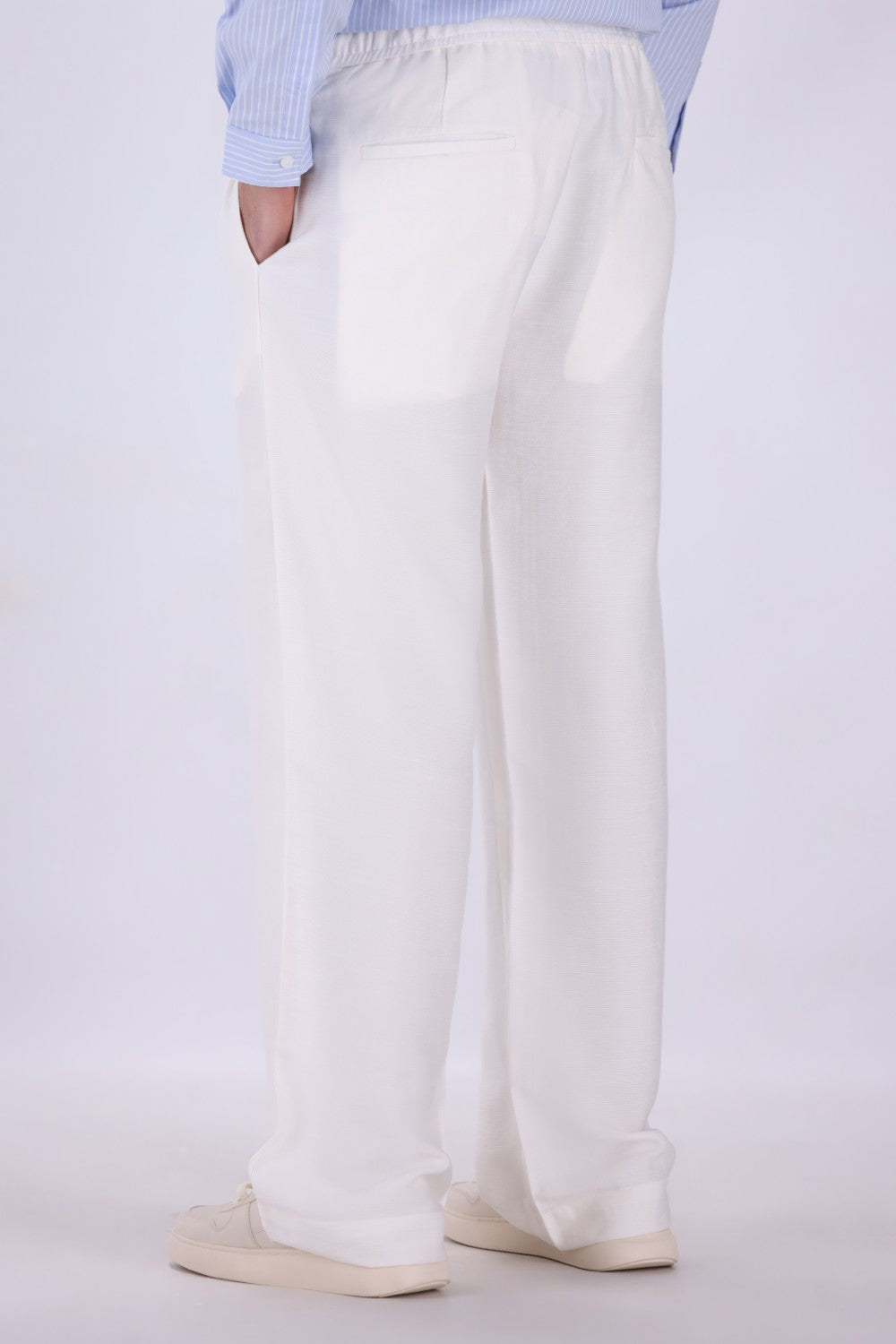 White pull-on trousers worn with loafers

