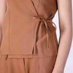 Wrap vest layered over a fitted tee
