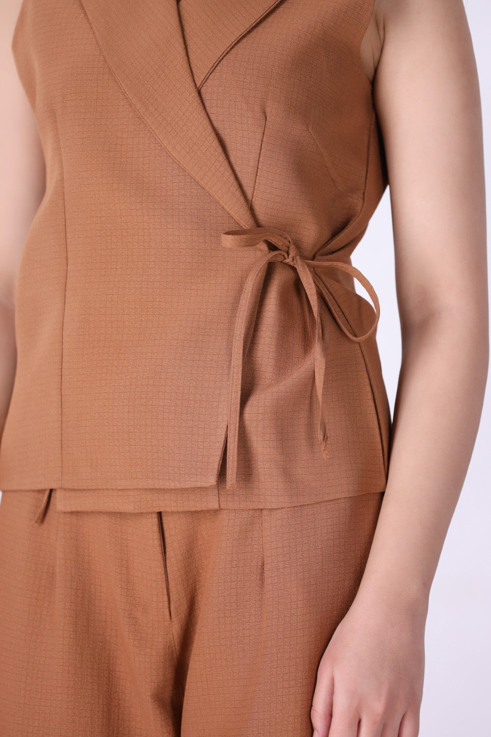 Wrap vest layered over a fitted tee
